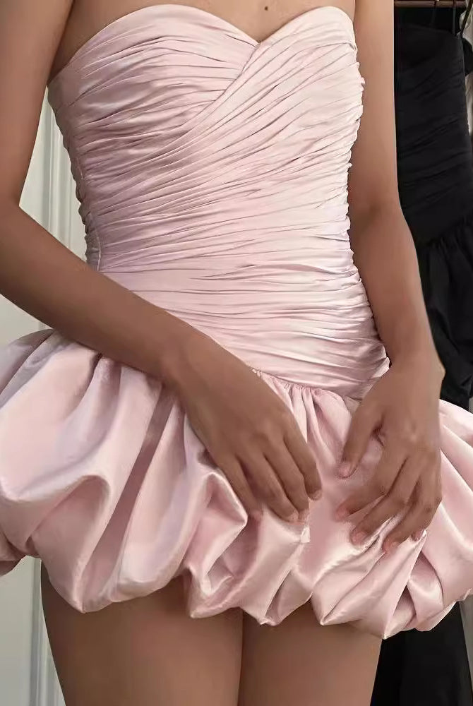 Strapless pink dress with ruched bodice and bubble hem, ideal for elegant fashion occasions