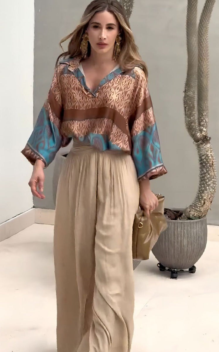 Elegant two piece set featuring woman in patterned blouse and wide-leg pants with free shipping