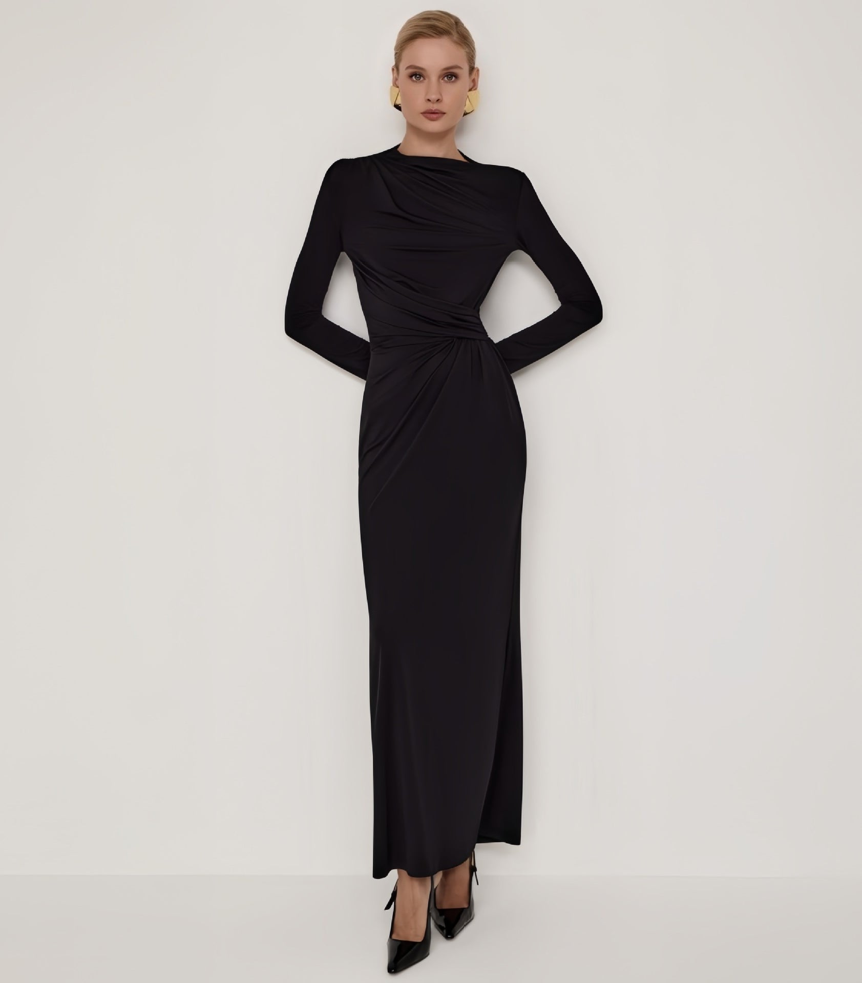 Sleek black maxi dress with draped waist, high slit, and fitted pleats