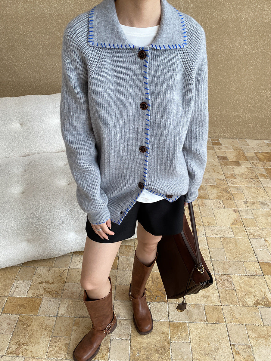 Light gray knit cardigan coat with square neckline, dark buttons, and regular sleeves