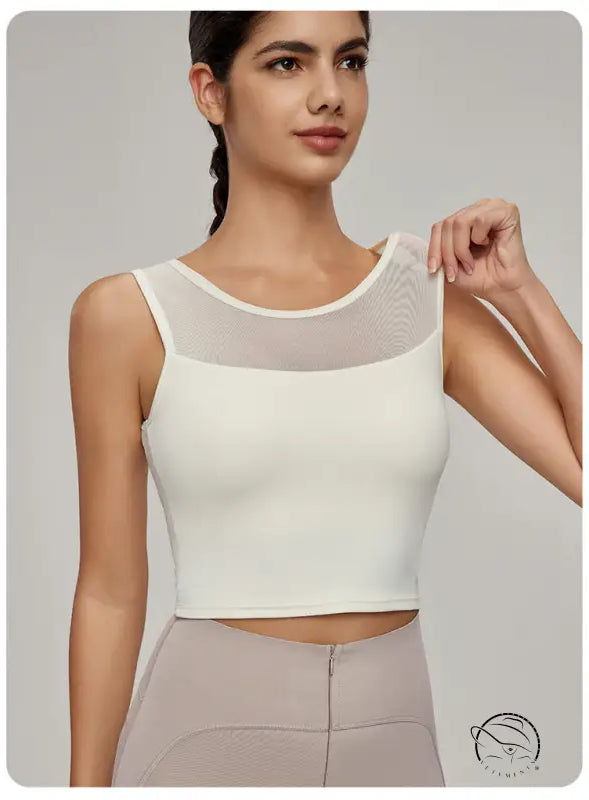 Woman in Beauty Back Mesh Workout Top over light brown pants