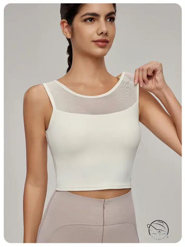 Woman in Beauty Back Mesh Workout Top over light brown pants