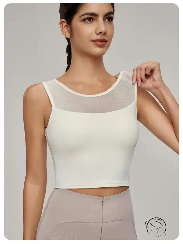 Woman in Beauty Back Mesh Workout Top over light brown pants