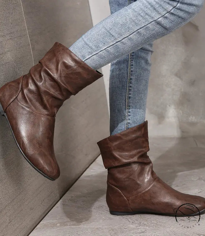 Brown low heel faux leather boots with slouchy ankle design