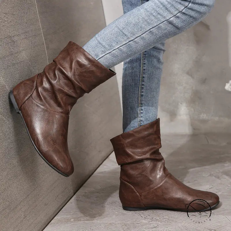 Brown low heel faux leather boots with slouchy ankle design