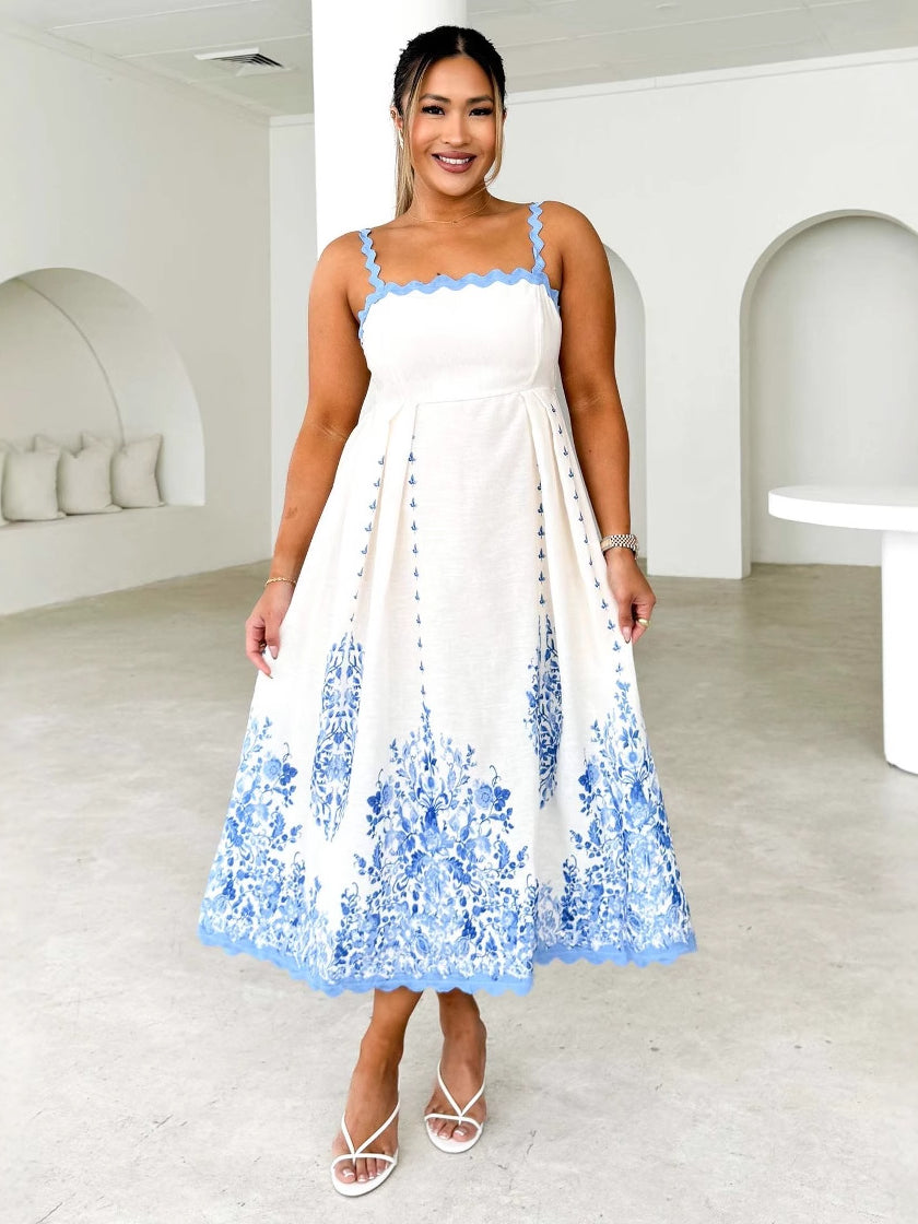 White backless dress with blue floral embroidery, perfect for summer fashion ملابس
