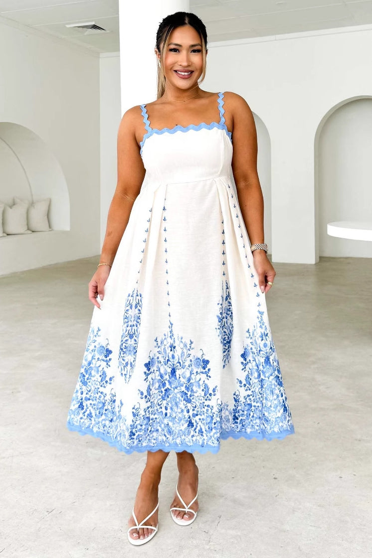 White backless dress with blue floral embroidery, perfect for summer fashion ملابس