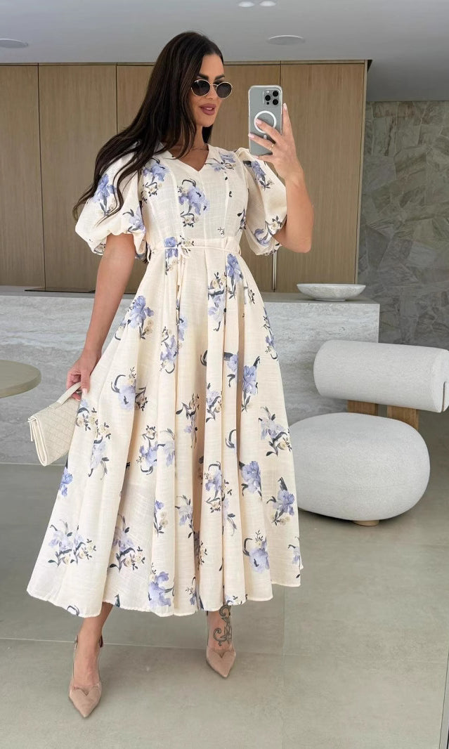 Floral print midi dress featuring elegant puff sleeves, perfect for trendy fashion looks
