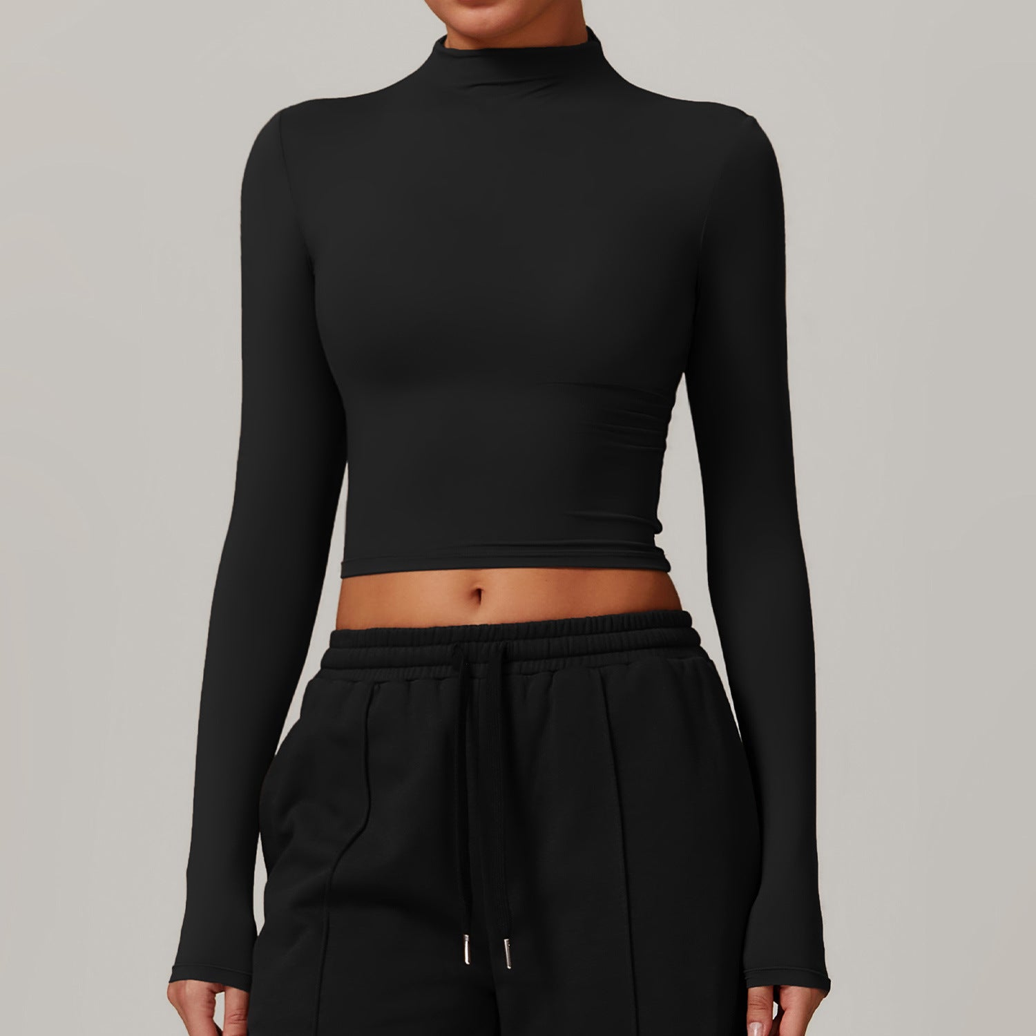 Black long-sleeved crop top with mock neckline, ideal for Langry fitness fashion ملابس