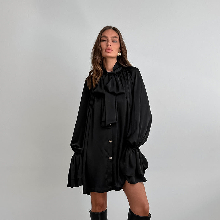Black satin dress with puff sleeves and ruffled hem, perfect for elegant fashion looks