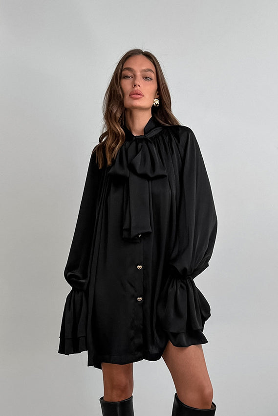 Black satin dress with puff sleeves and ruffled hem, perfect for elegant fashion looks