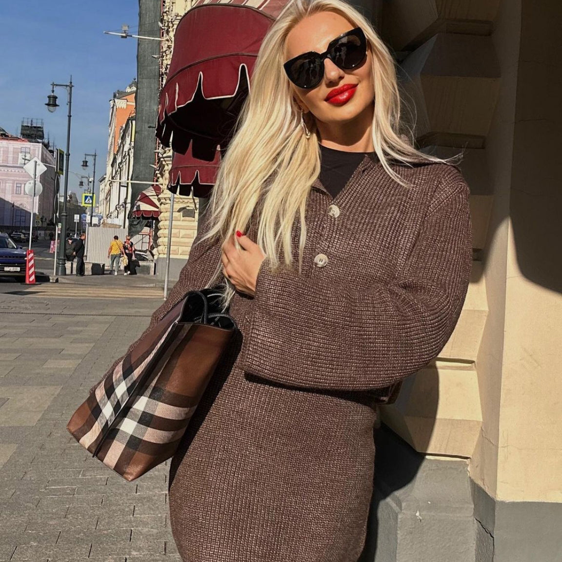 Blonde woman in brown knit cardigan and skirt set showcasing stylish Woolen Sets fashion