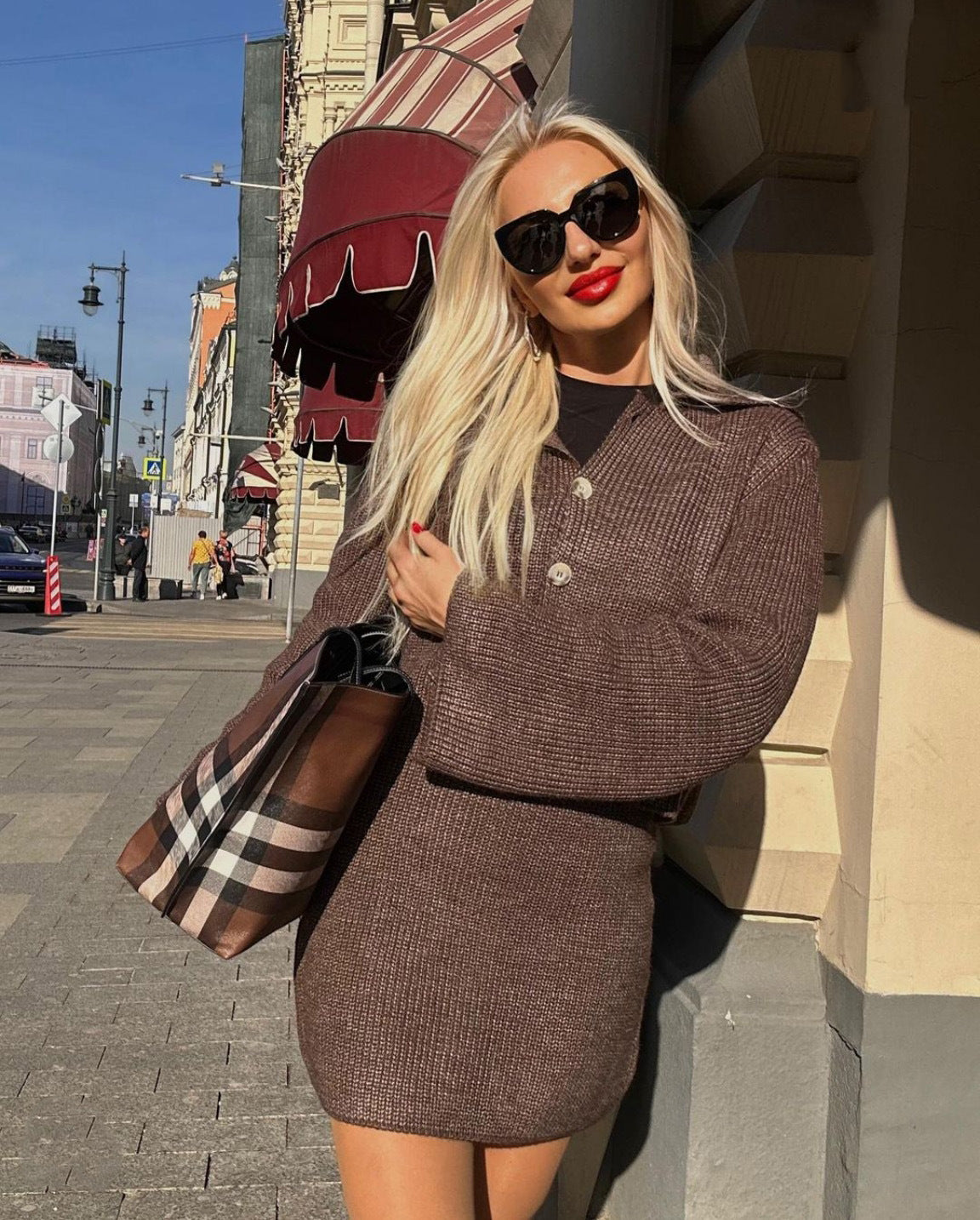 Blonde woman in brown knit cardigan and skirt set showcasing stylish Woolen Sets fashion