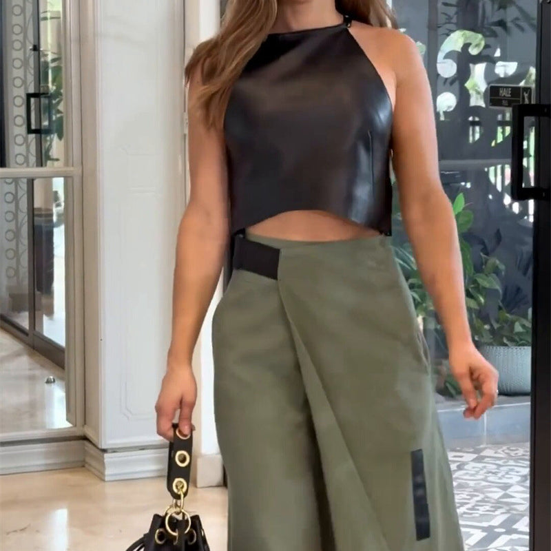 Elegant woman wearing black leather halter top and olive green wrap skirt in fashionable ملابس style