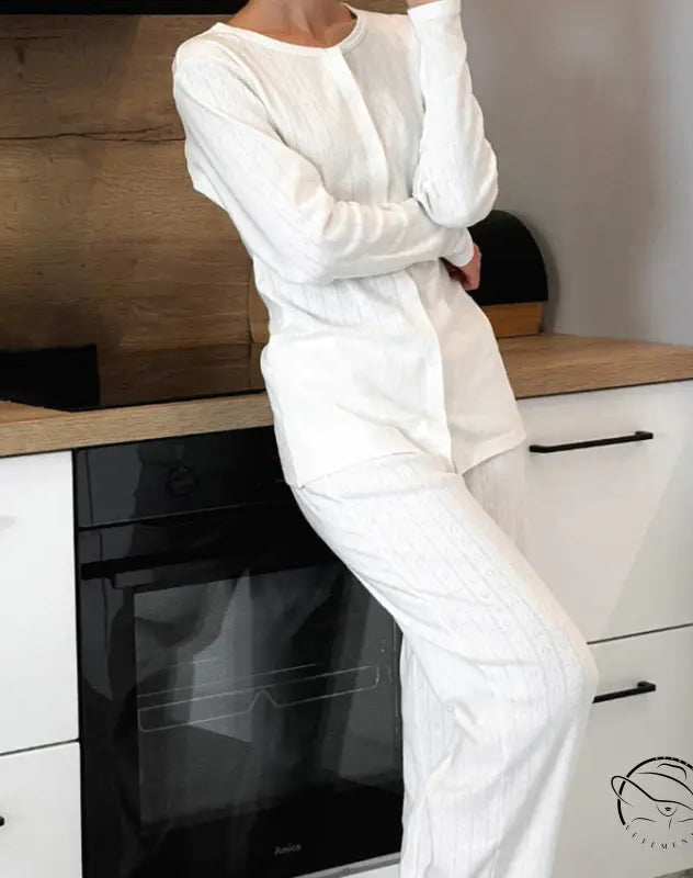 Woman in white long-sleeved knitted jacquard pajamas jumpsuit