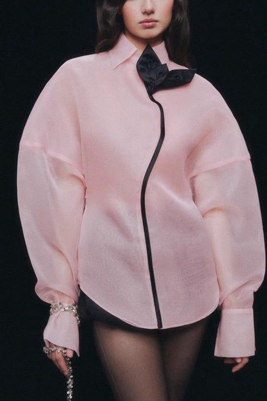 Pink langry fashion blouse with black accents and bow detail