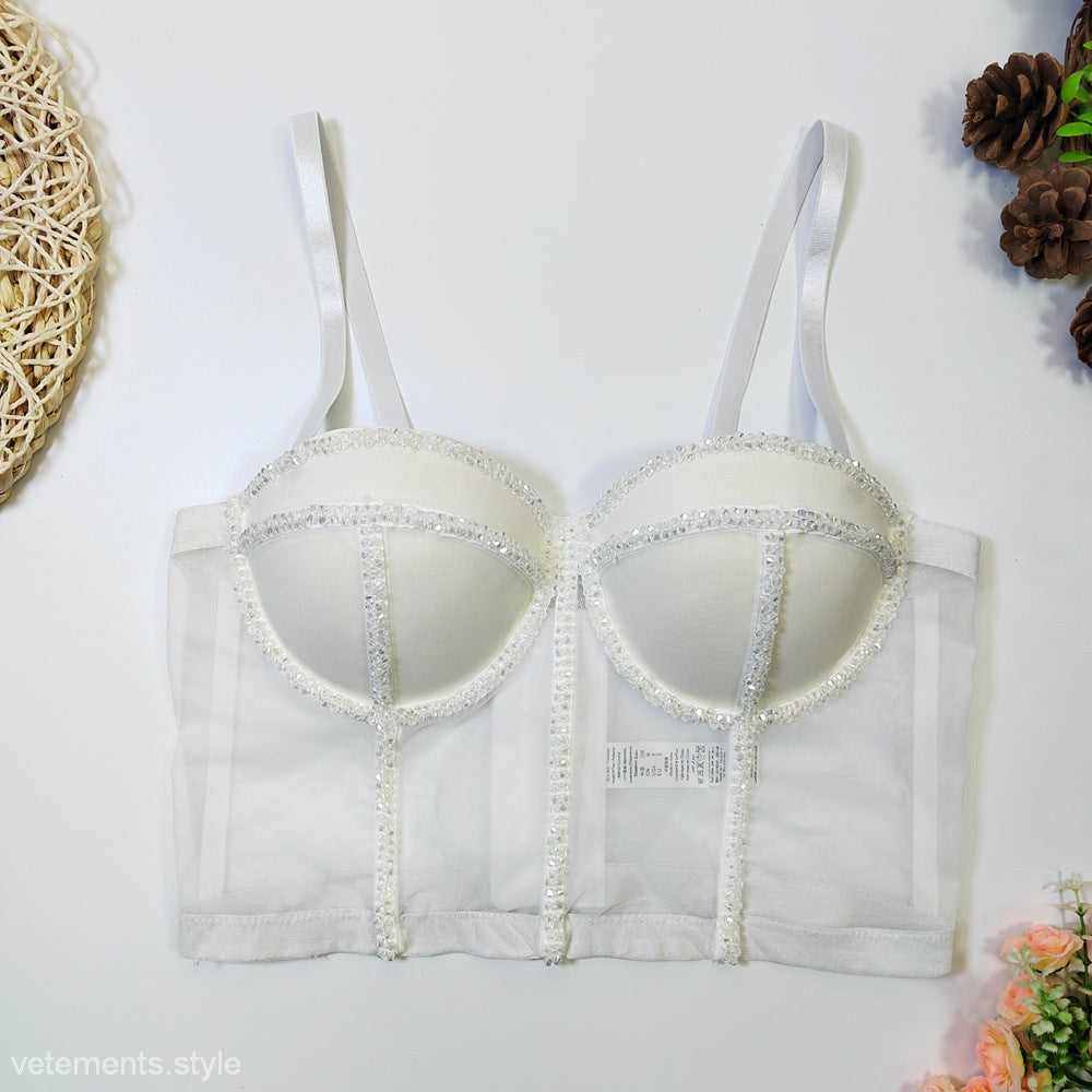 Elegant white lace-trimmed bustier with adjustable straps atop a black crystal background