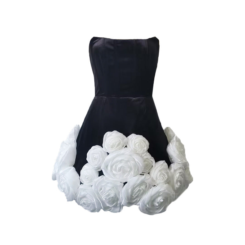 Black dress with white rose embellishments from French Design, perfect for elegant fashion occasions