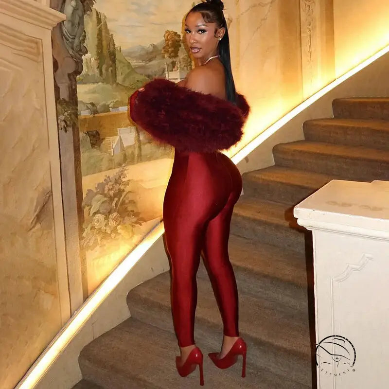 Red patent leather long sleeve furry jumpsuit with fur trim and heels
