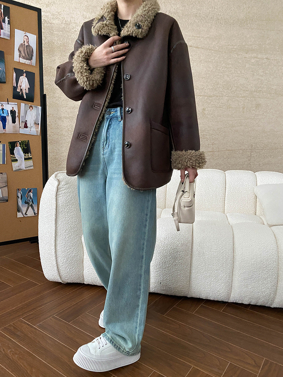 Brown shearling-trimmed jacket with light blue jeans and white sneakers in fashion ملابس