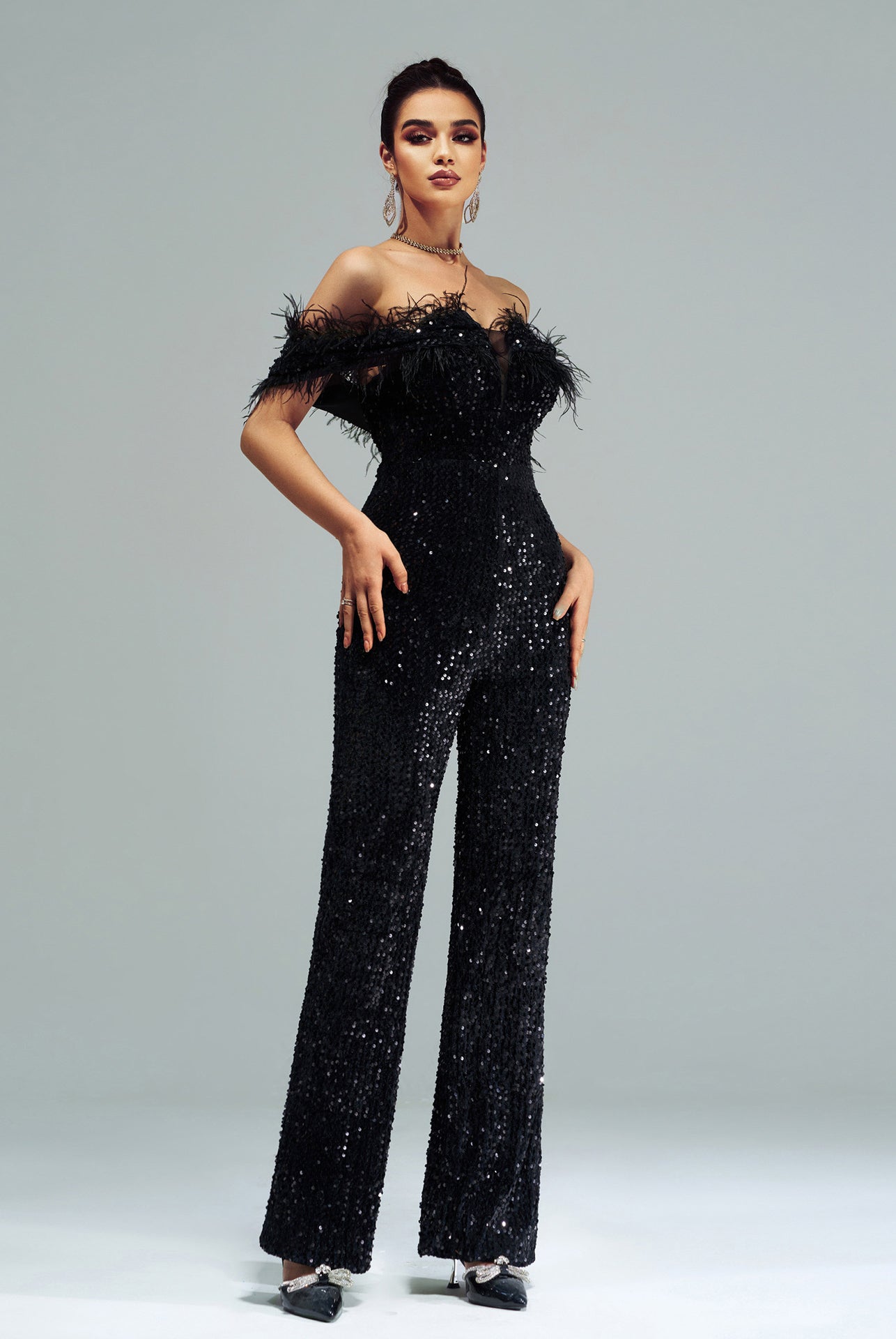Sequin-covered black jumpsuit with feather trim, high-end fashion ملابس for elegant events