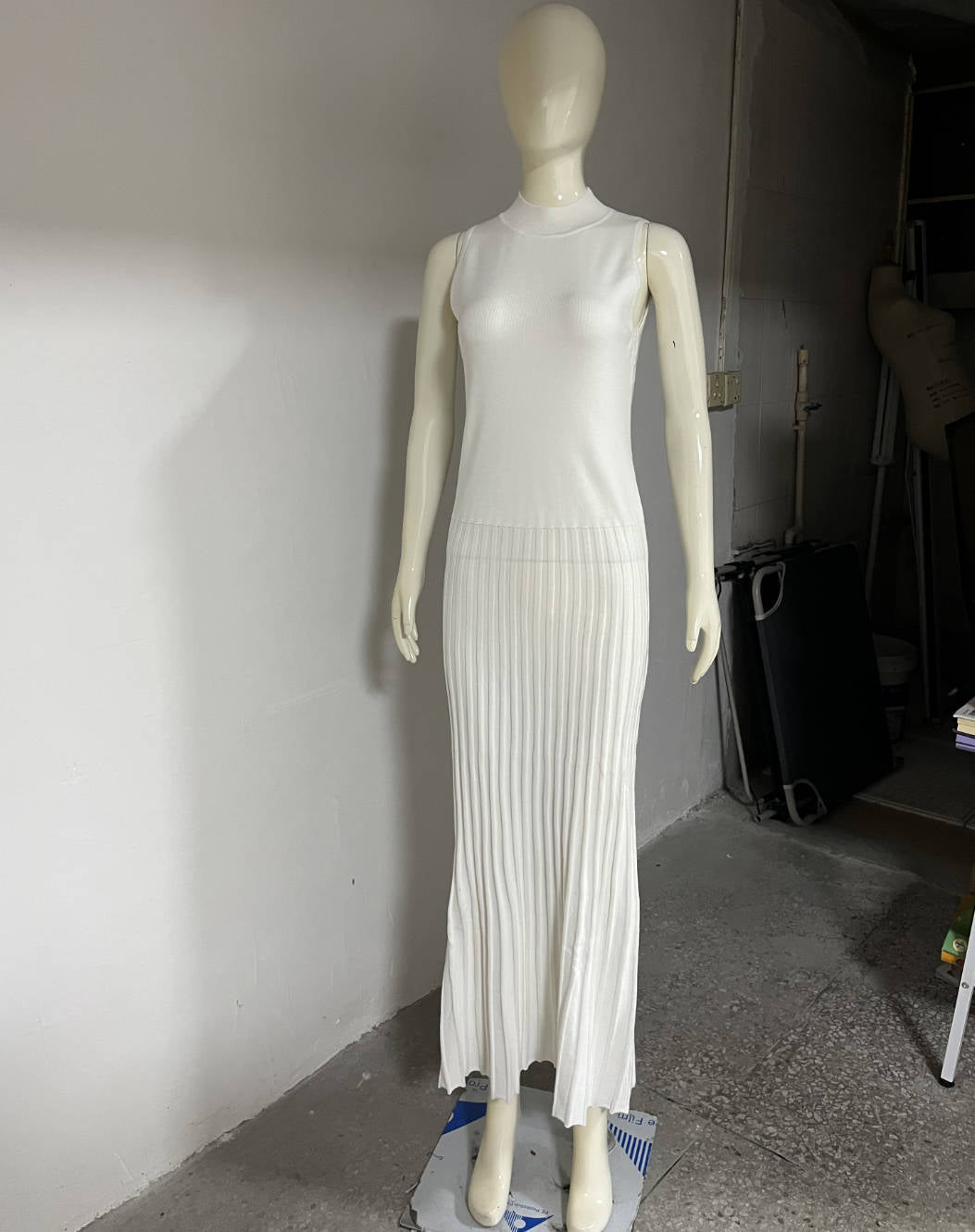 White sleeveless ribbed maxi dress on mannequin, showcasing elegant fashion design