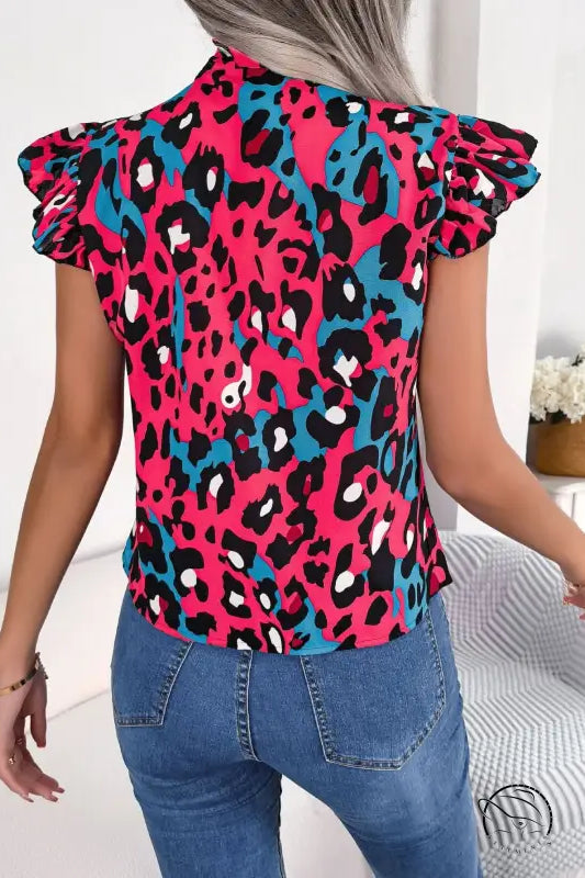 Casual leopard print blouse in fuchsia, black, and teal with ruffles