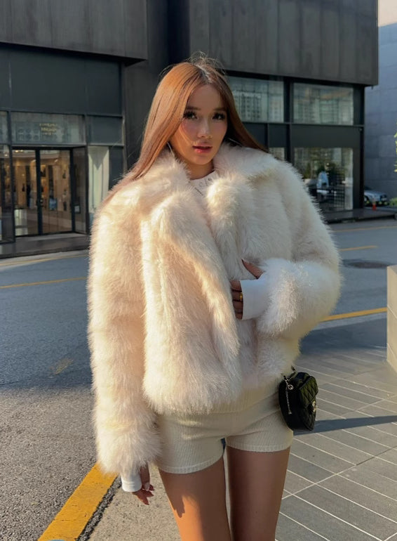 Cream faux fur oversized coat with fluffy texture and wide collar