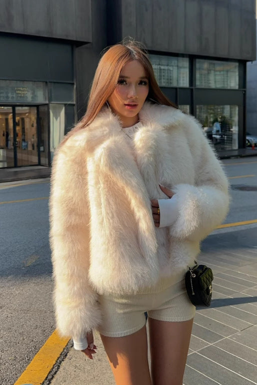 Cream faux fur oversized coat with fluffy texture and wide collar
