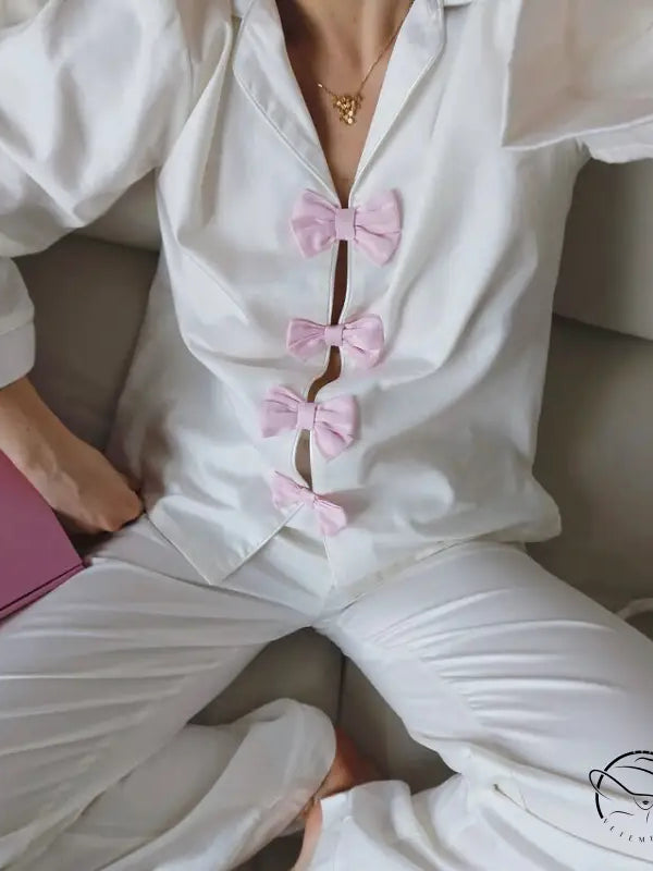 Elegant white satin langry pajama set with pink bows and gold necklace