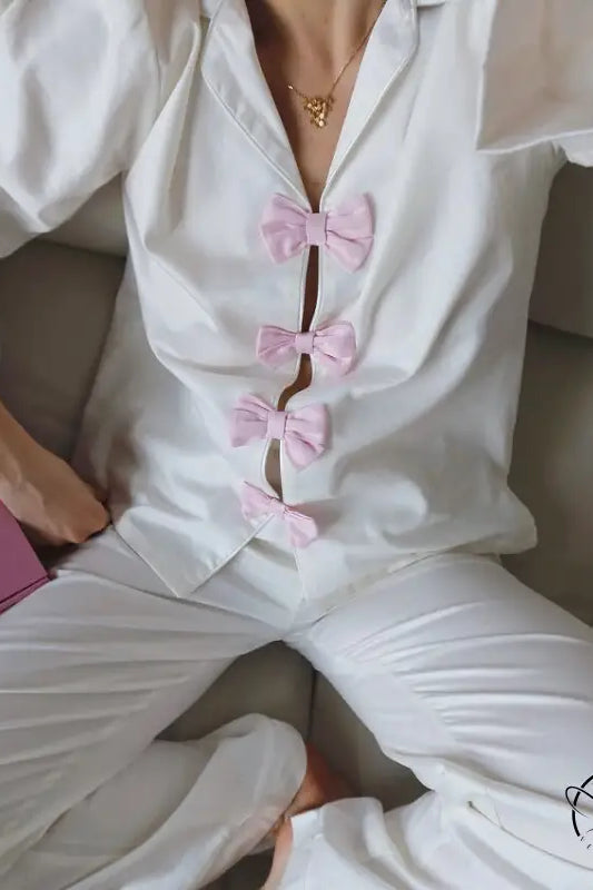 Elegant white satin langry pajama set with pink bows and gold necklace