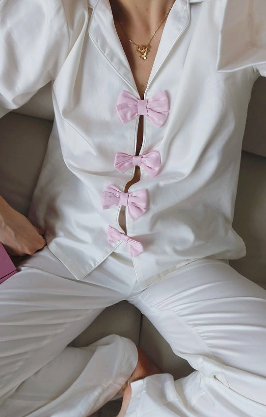 Elegant white satin langry pajamas with pink bows and gold necklace