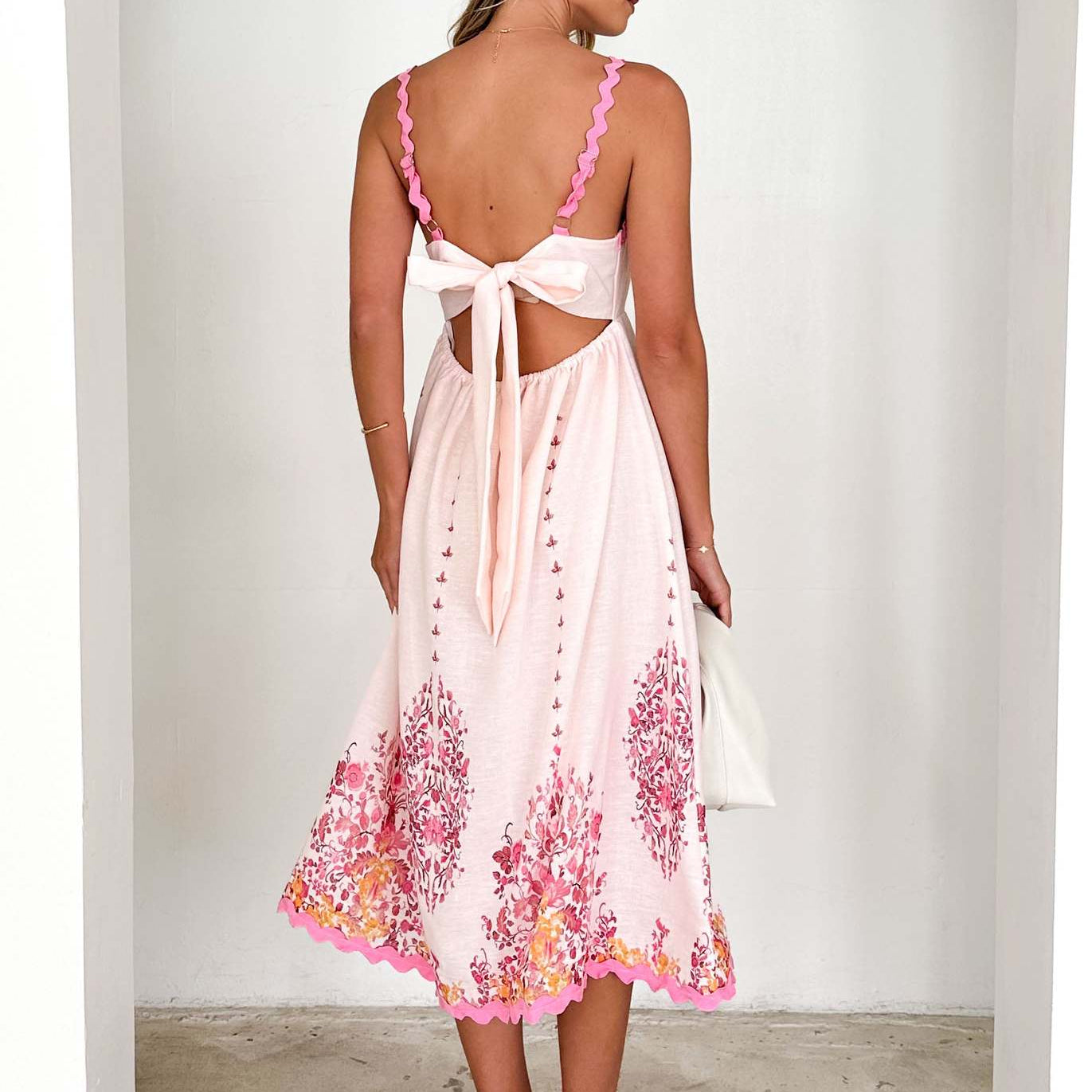 White sundress with pink floral details, perfect for langry fashion and ملابس styles
