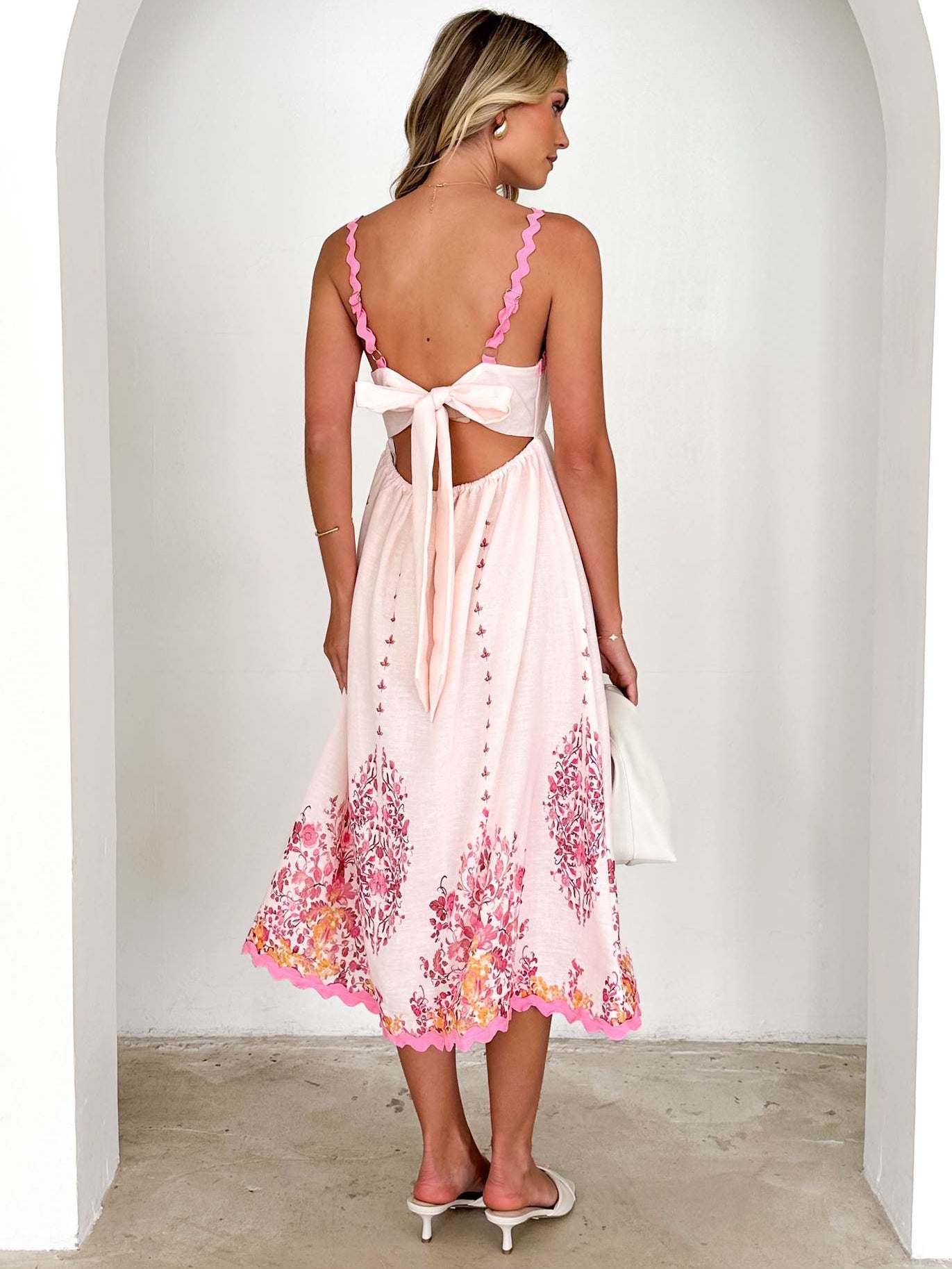White sundress with pink floral details, perfect for langry fashion and ملابس styles