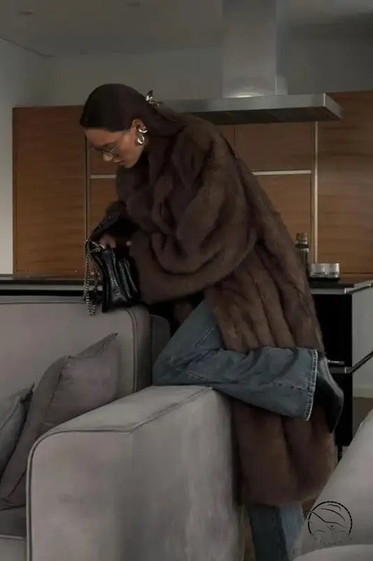 Brown faux fur vintage Langry fox jacket with blue jeans and black boots