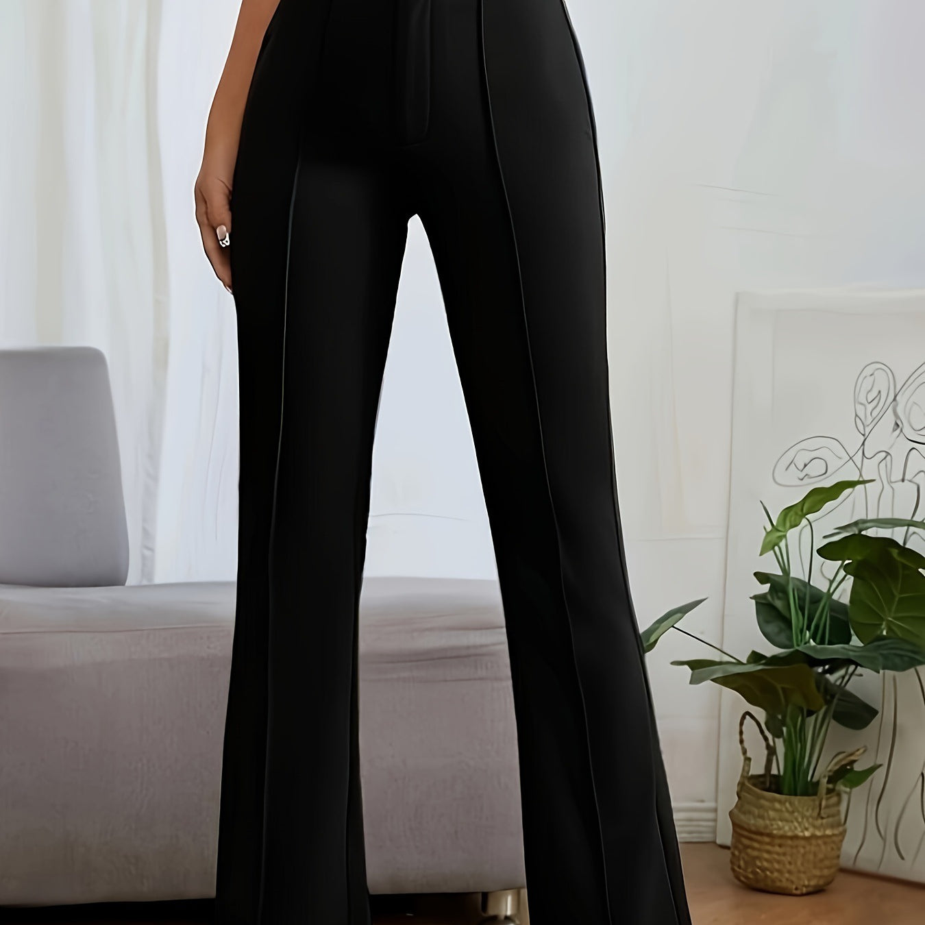 Black high-waisted flared dress pants featuring center seam detail for stylish casual fashion