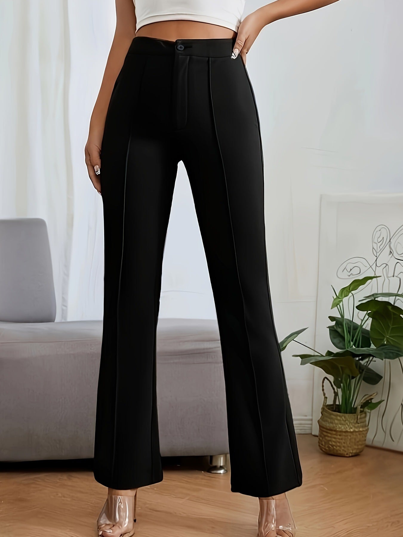 Black high-waisted flared dress pants featuring center seam detail for stylish casual fashion