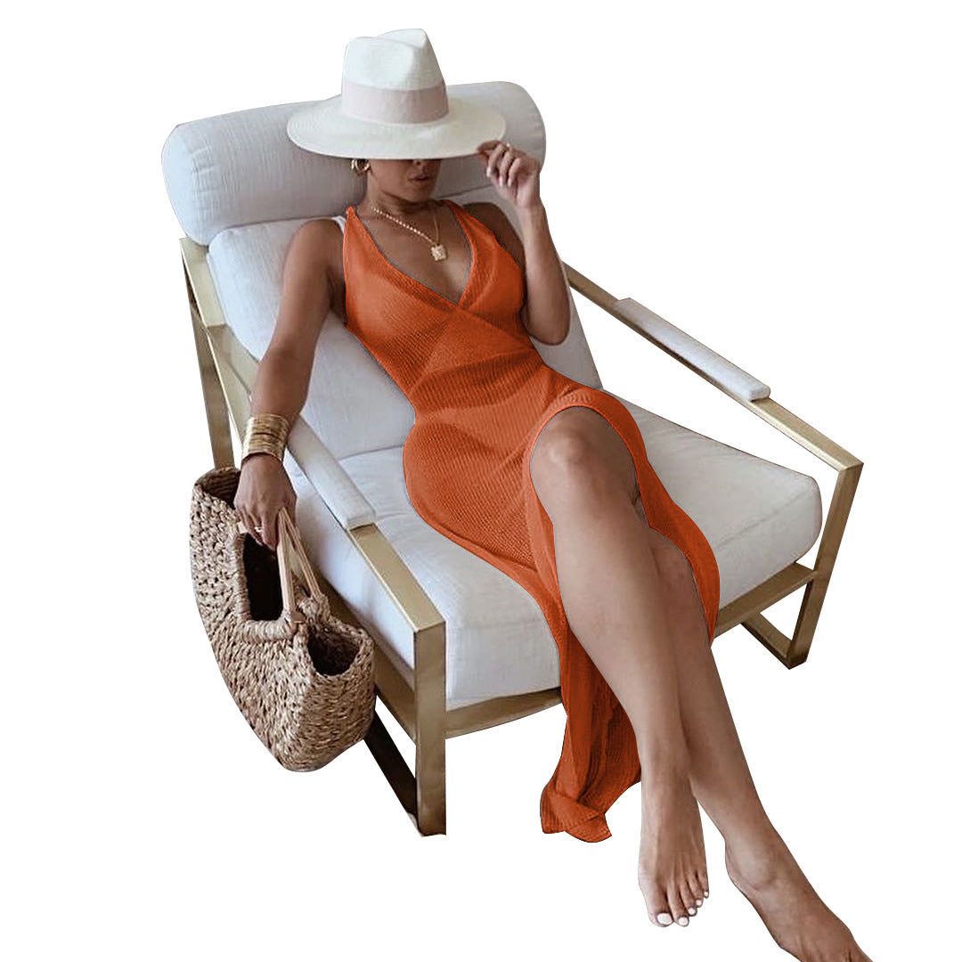 Woman in light camel knitted beach maxi dress with white hat for summer fashion