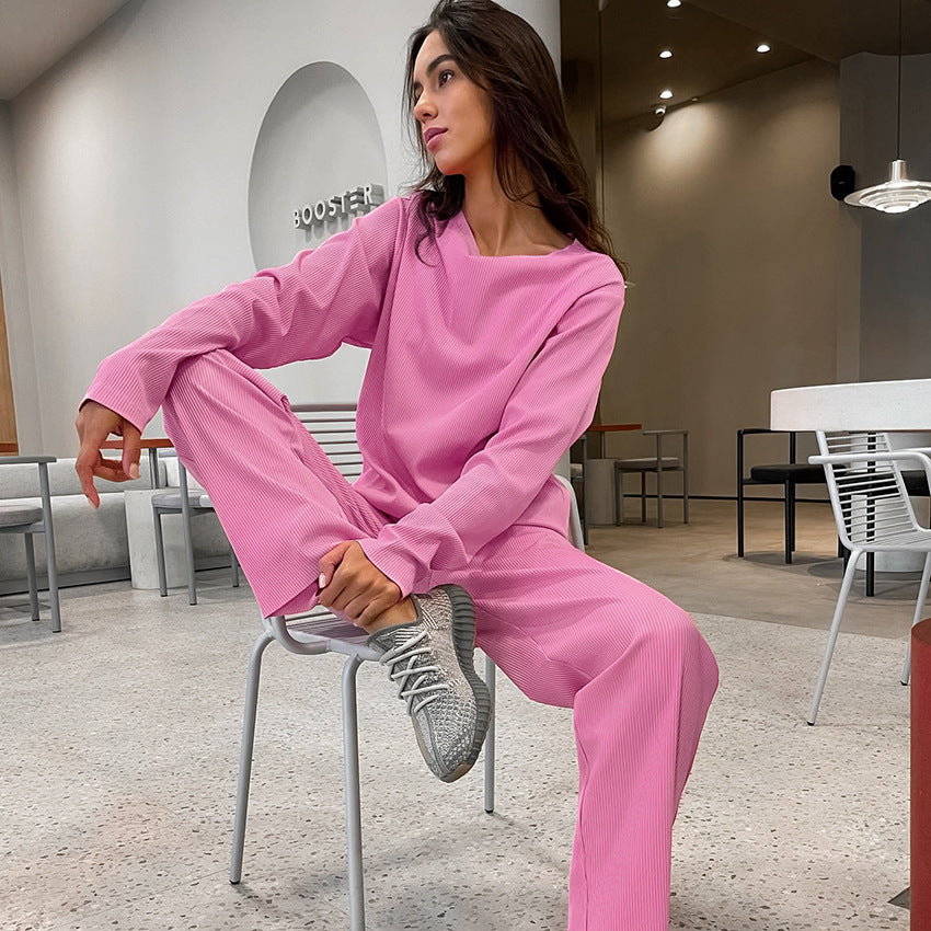 Pink knitted pajamas two piece set with long-sleeved top, wide-leg pants, and gray athletic shoes