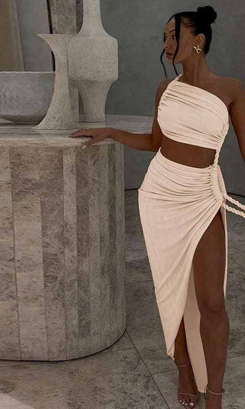 Woman in a one-shoulder crop top and high-slit skirt showcasing Stunning Cutout Lace Pleated Dress