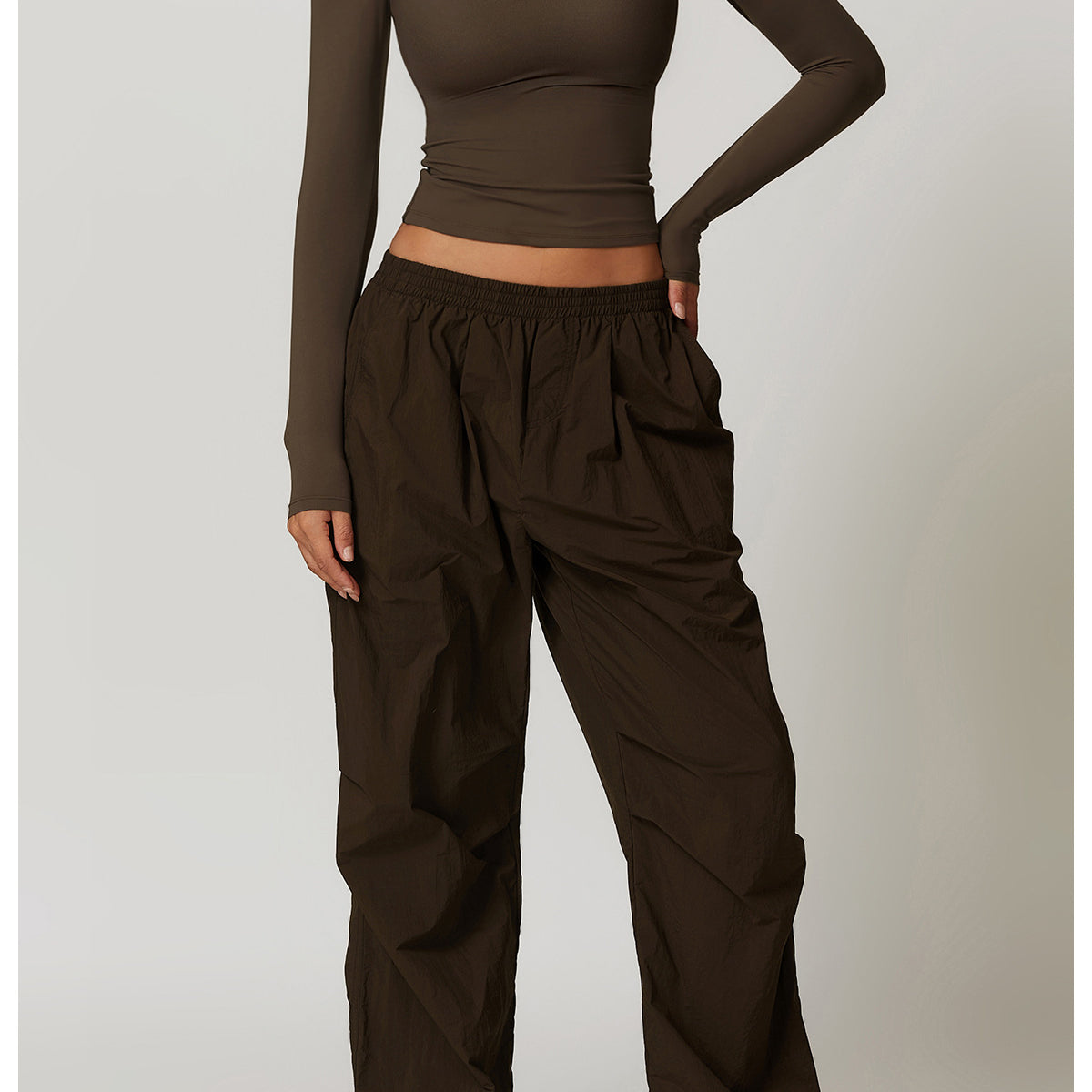 Olive green long-sleeved top and baggy pants outfit for winter yoga fashion with quick-drying features