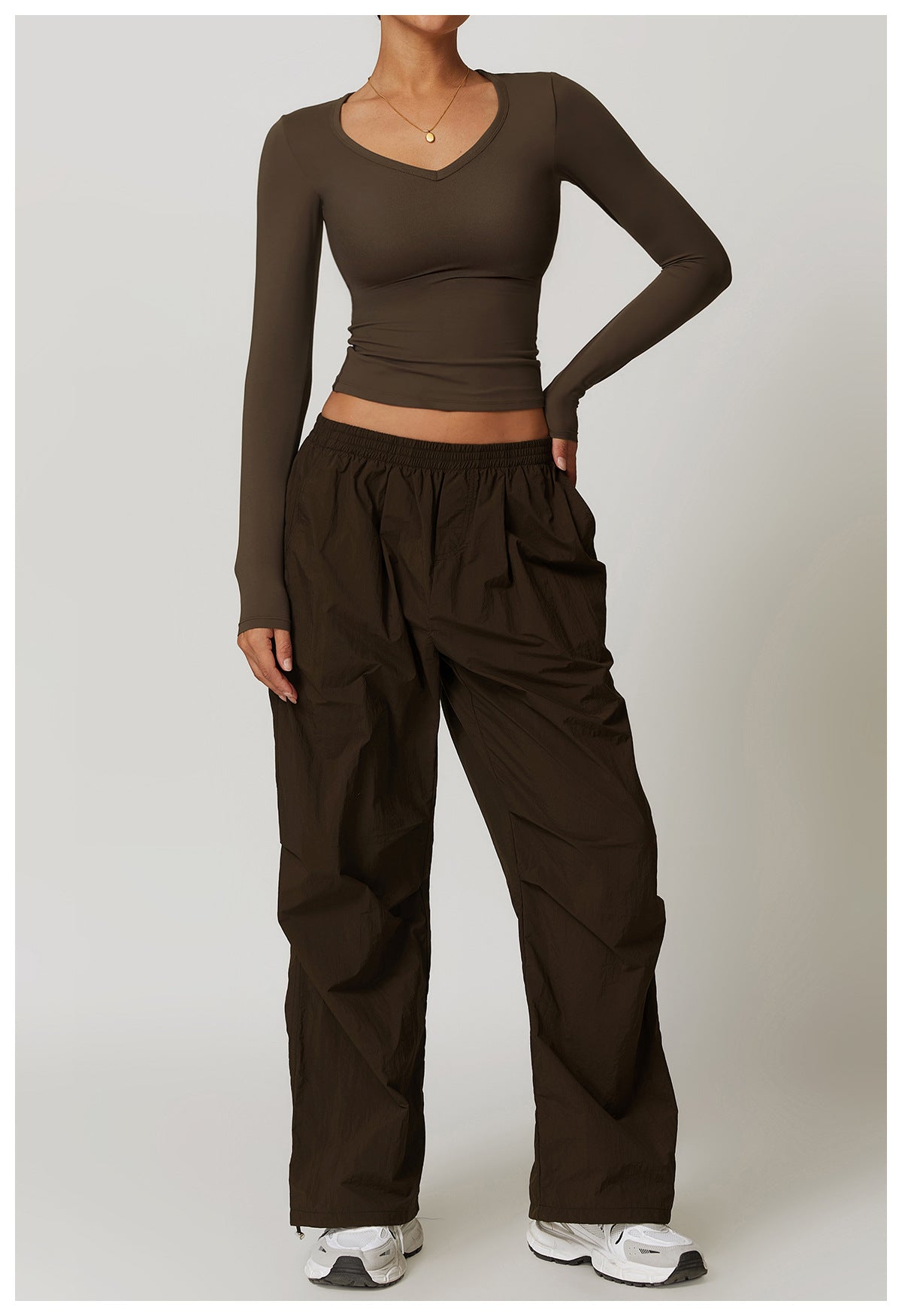 Olive green long-sleeved top and baggy pants outfit for winter yoga fashion with quick-drying features