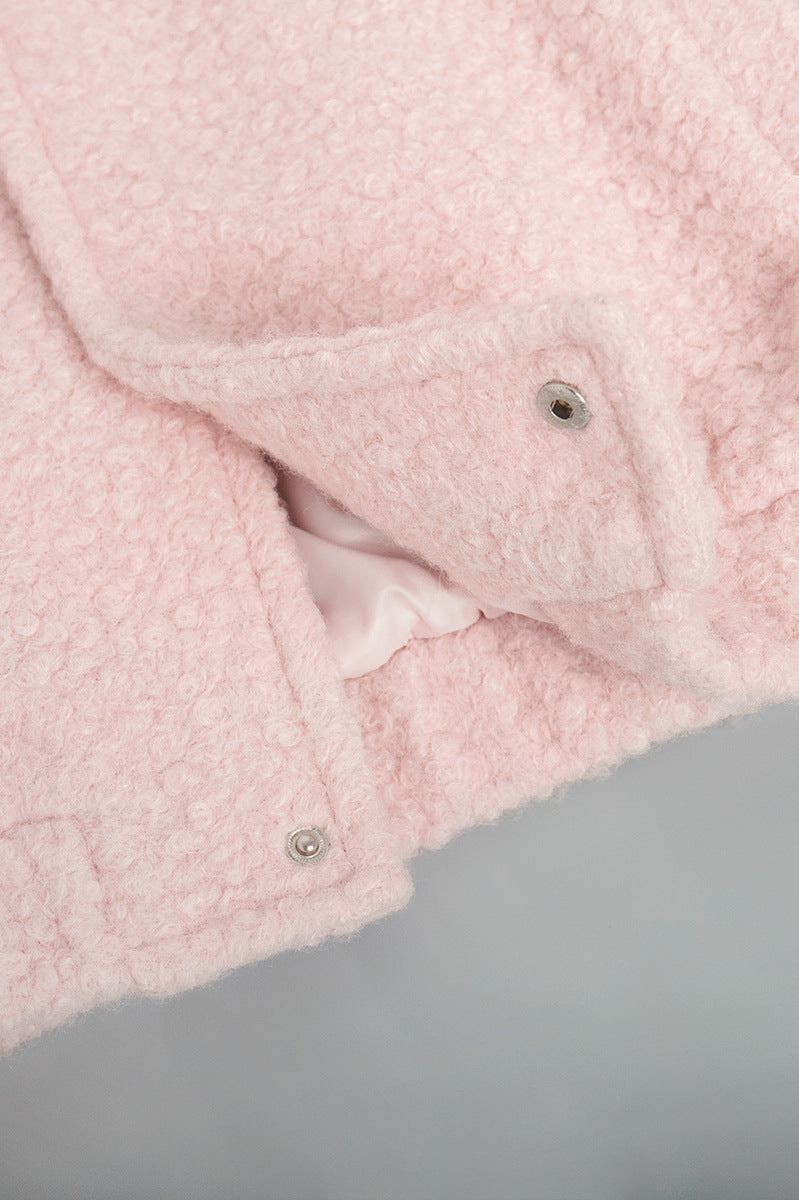 Pink short furry coat with fuzzy texture and snap closures for stylish warmth