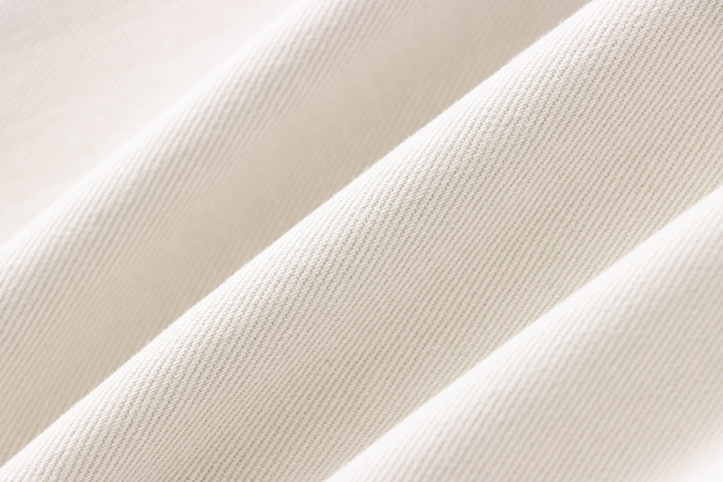 Diagonal folds of cream fabric with ribbed texture on Street Design Wide Leg Jeans, ملابس