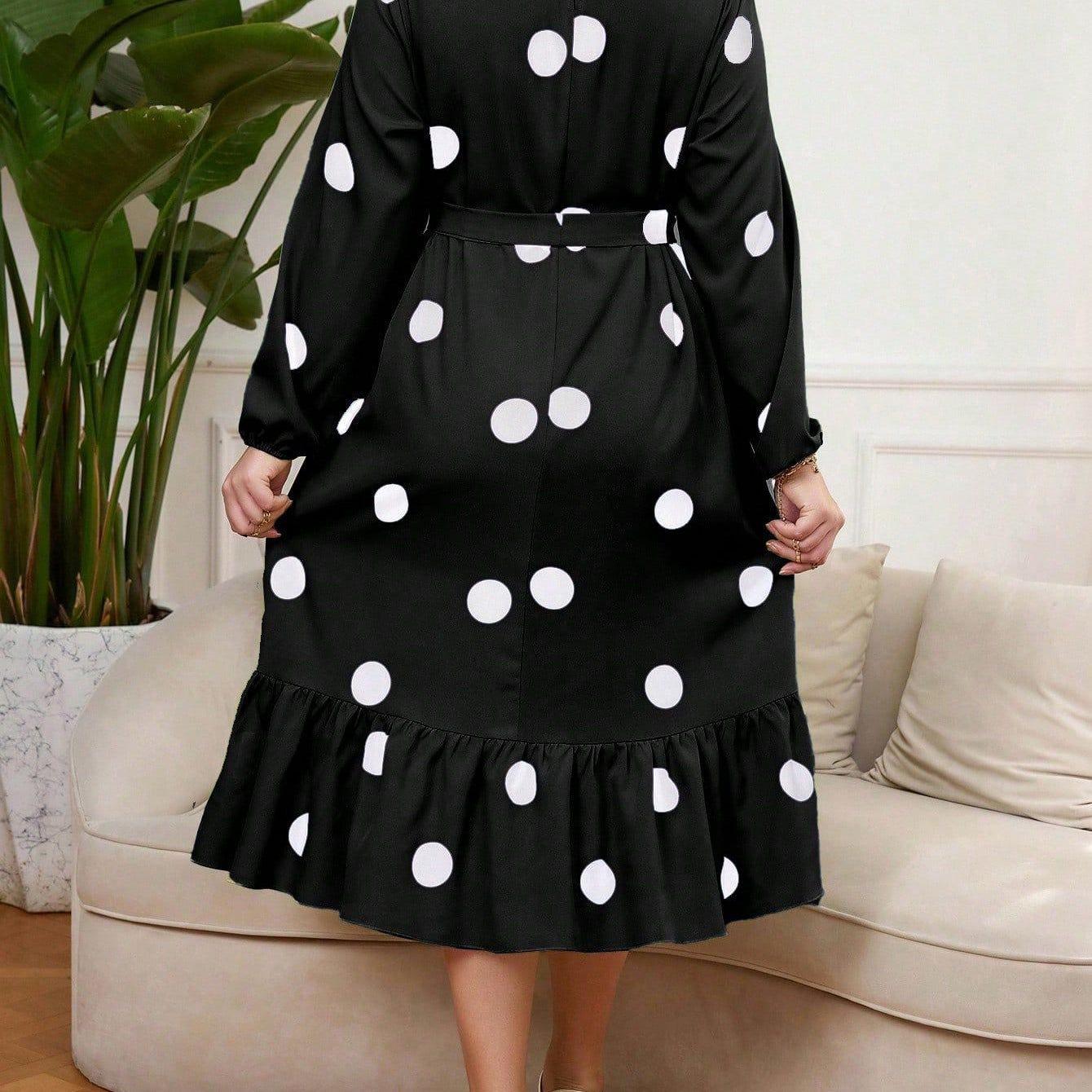 Black polka dot Lotus Leaf Dress with ruffled hem and long sleeves for elegant style