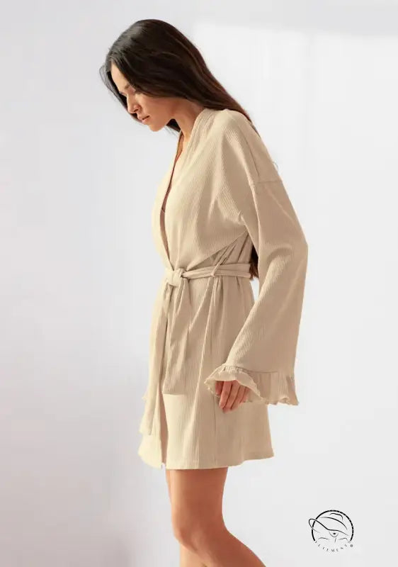 Woman in knitted casual cardigan nightgown with beige robe and ruffles
