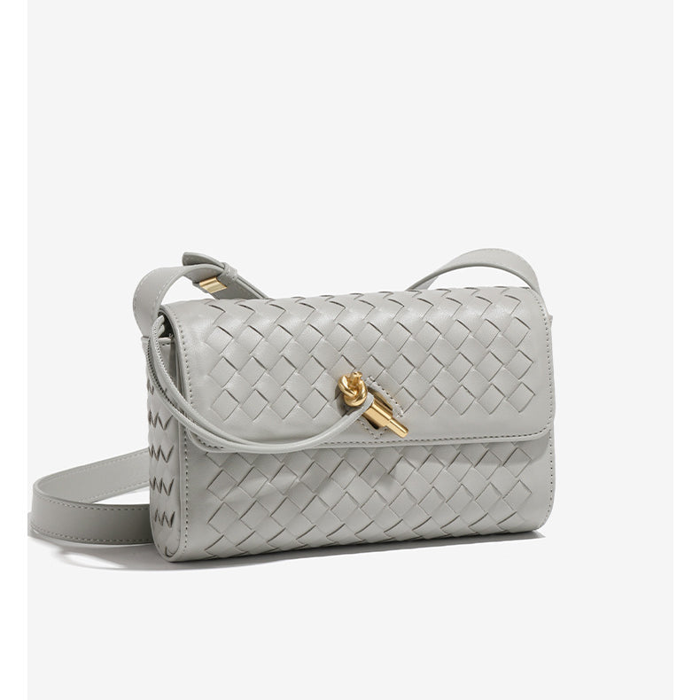 Gray woven leather shoulder bag with gold clasp, a stylish addition to any fashion ensemble