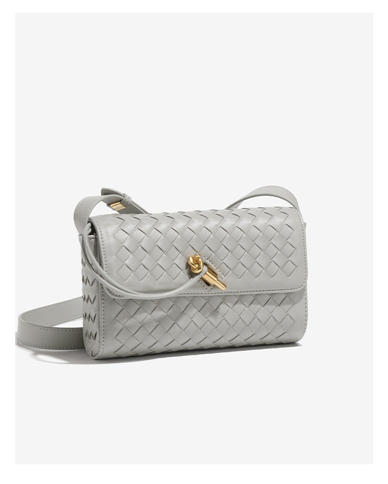 Gray woven leather shoulder bag with gold clasp, a stylish addition to any fashion ensemble
