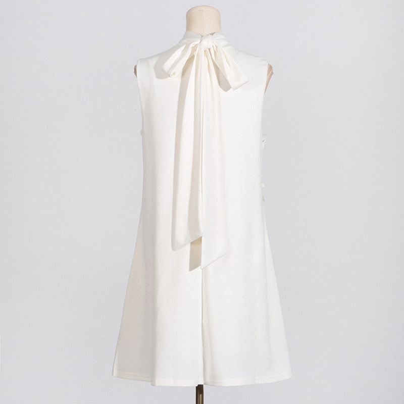 Sleeveless white dress with neck tie bow, vintage fashion style, perfect for summer