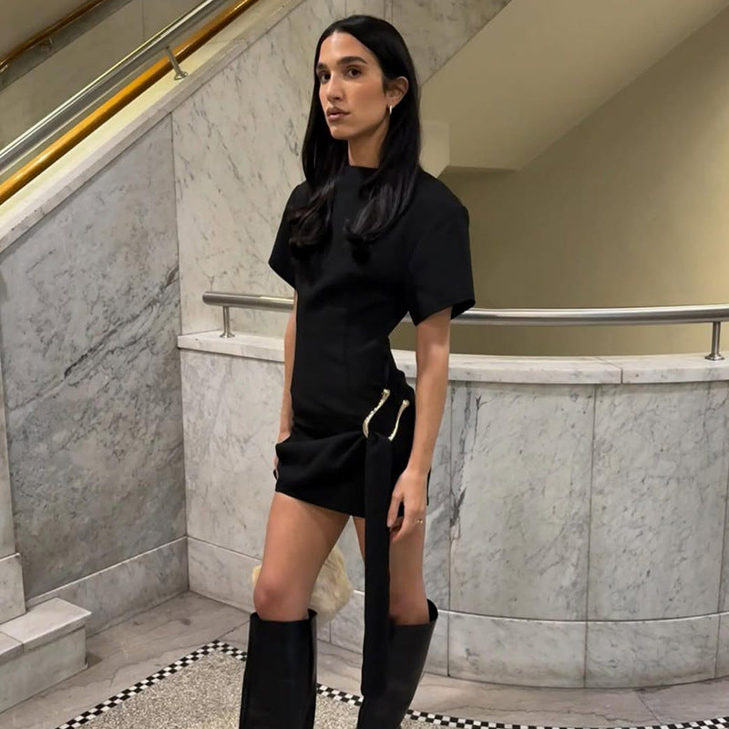 Woman in black mini dress and boots showcasing elegant langry fashion ملابس style